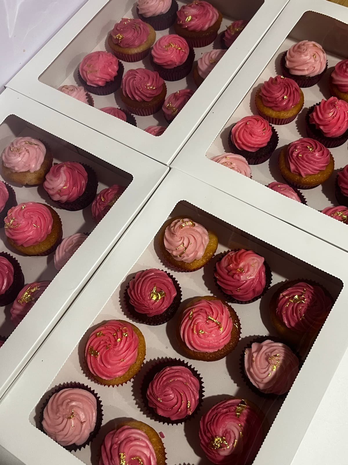 Boxes of blush-pink mini cupcakes with gold-leaf detail