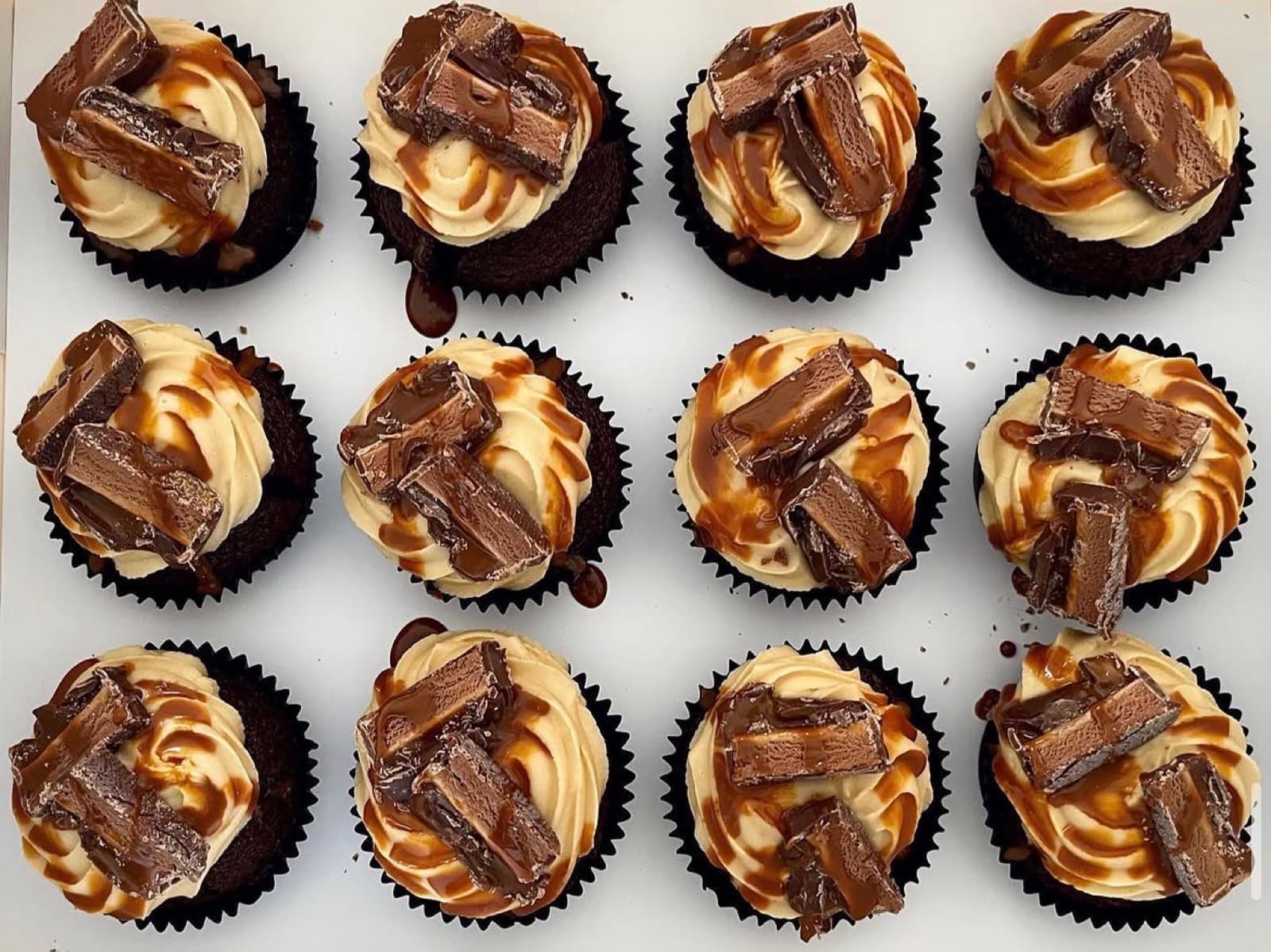 Chocolate cupcakes with caramel drizzle and chocolate-bar pieces
