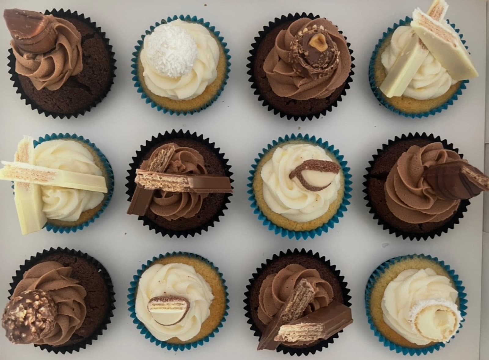 Assorted gourmet chocolate cupcakes with premium toppers