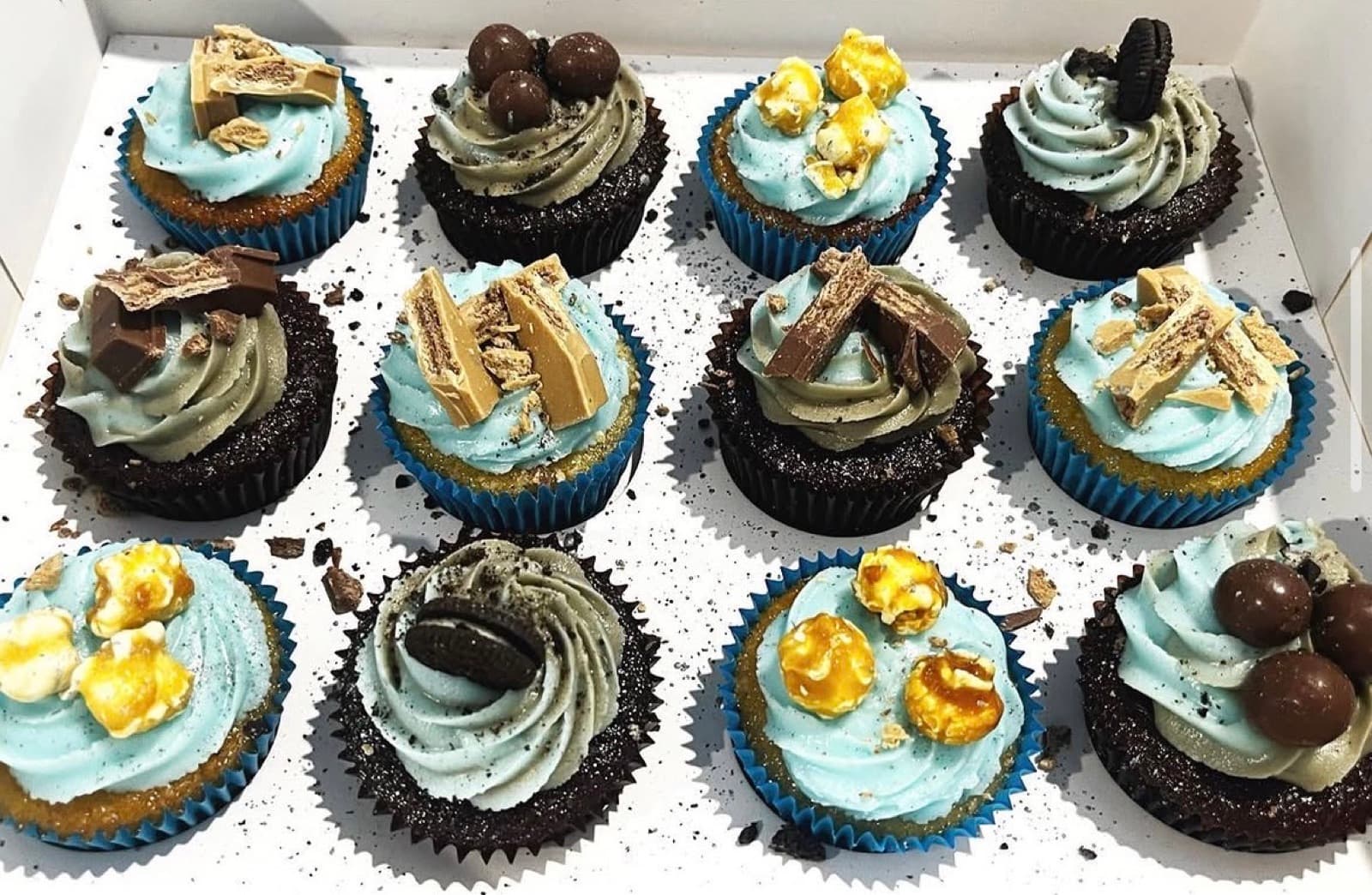 Chocolate cupcakes with blue frosting, honeycomb and Maltesers