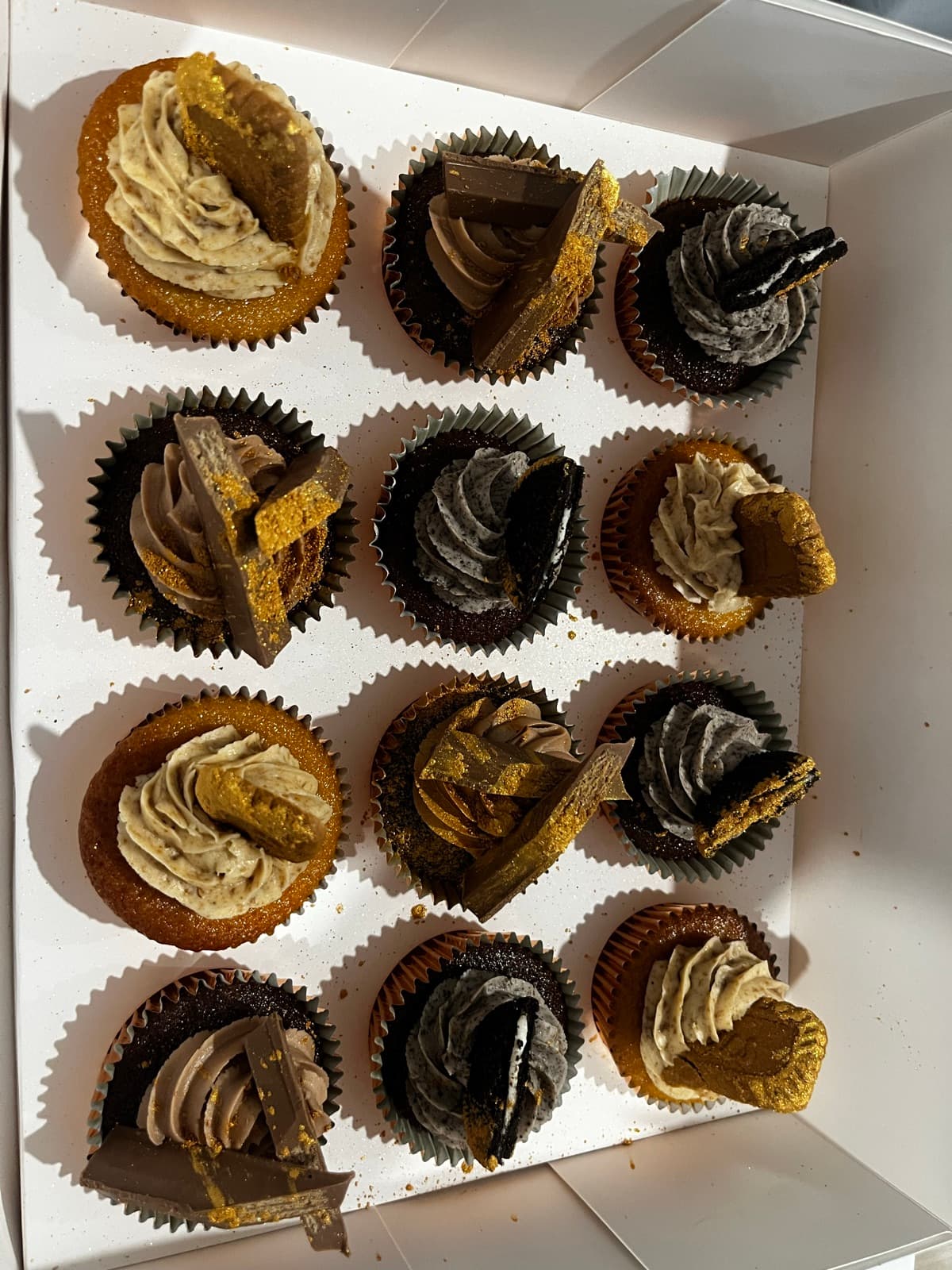Chocolate cupcakes with honeycomb, fudge and biscuit toppers