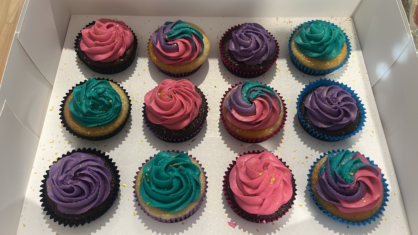 Cupcakes with pink, purple and teal buttercream swirls