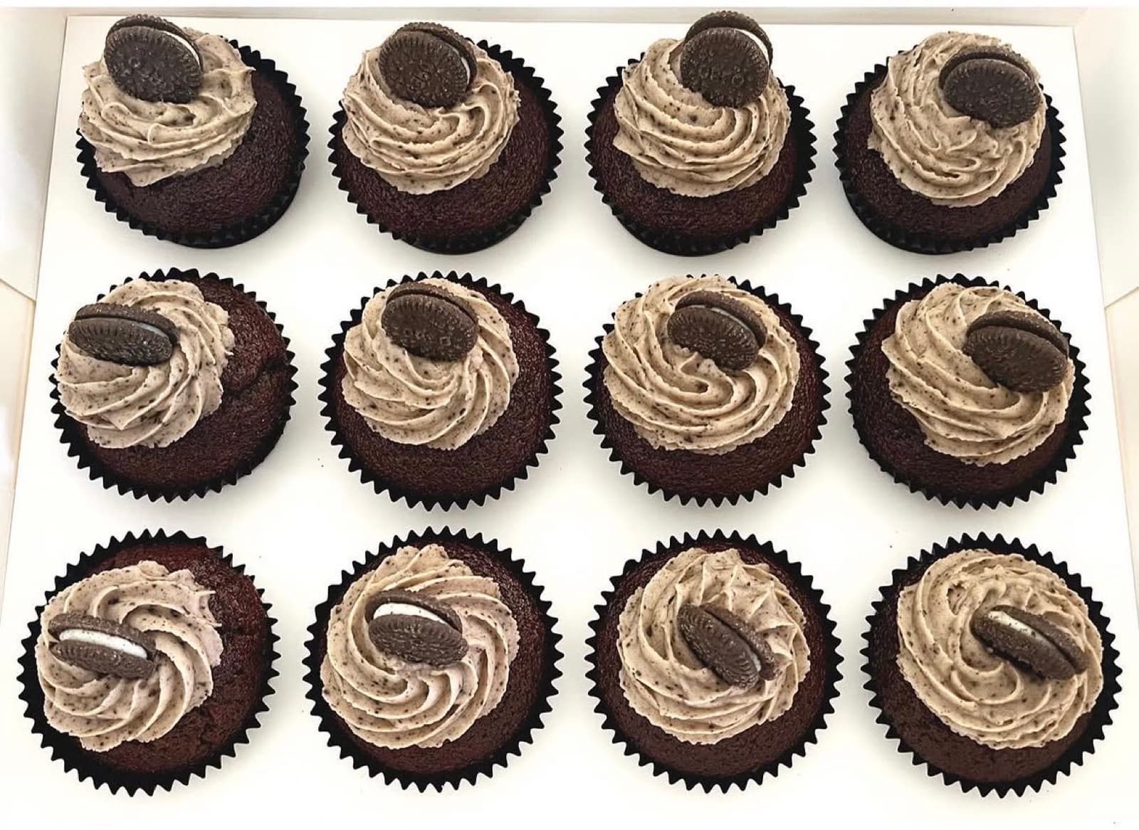 Cookies-and-cream chocolate cupcakes topped with mini Oreos