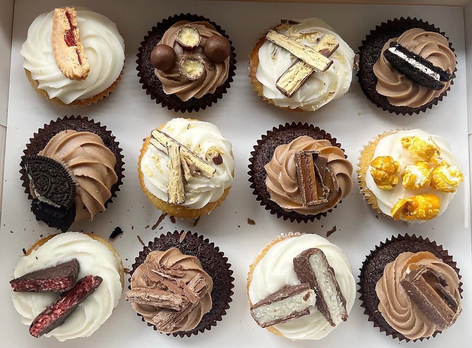 Assorted cupcakes topped with Oreo, Flake and caramel popcorn