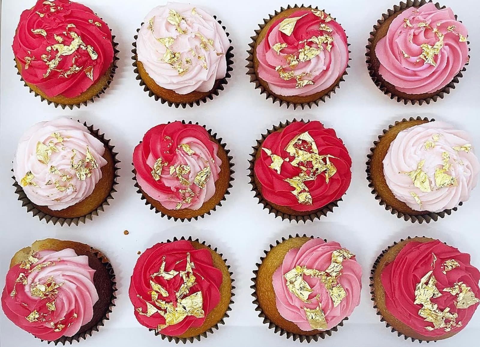Pink and magenta buttercream cupcakes finished with edible gold leaf
