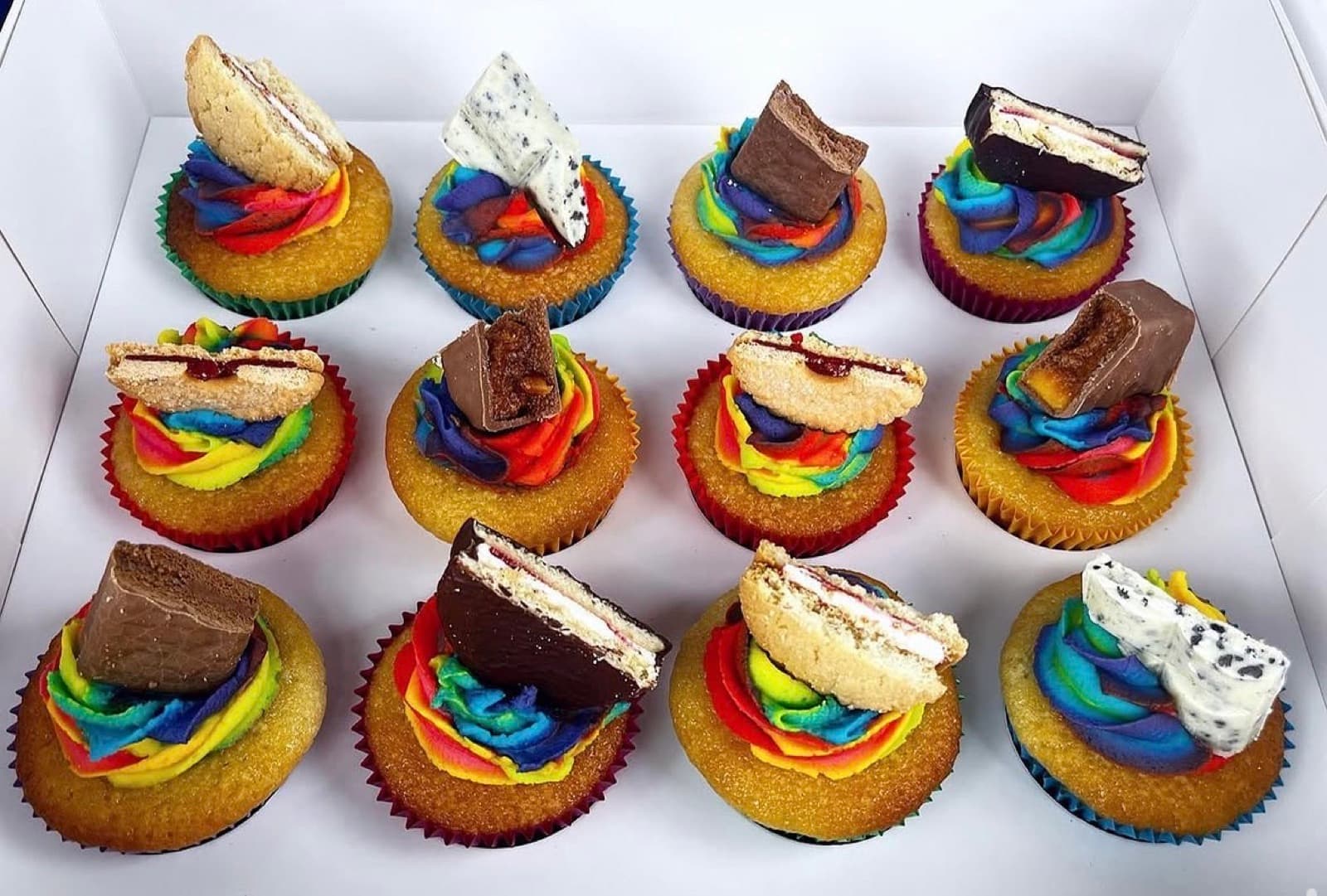 Rainbow swirl cupcakes topped with chocolate wafer bars