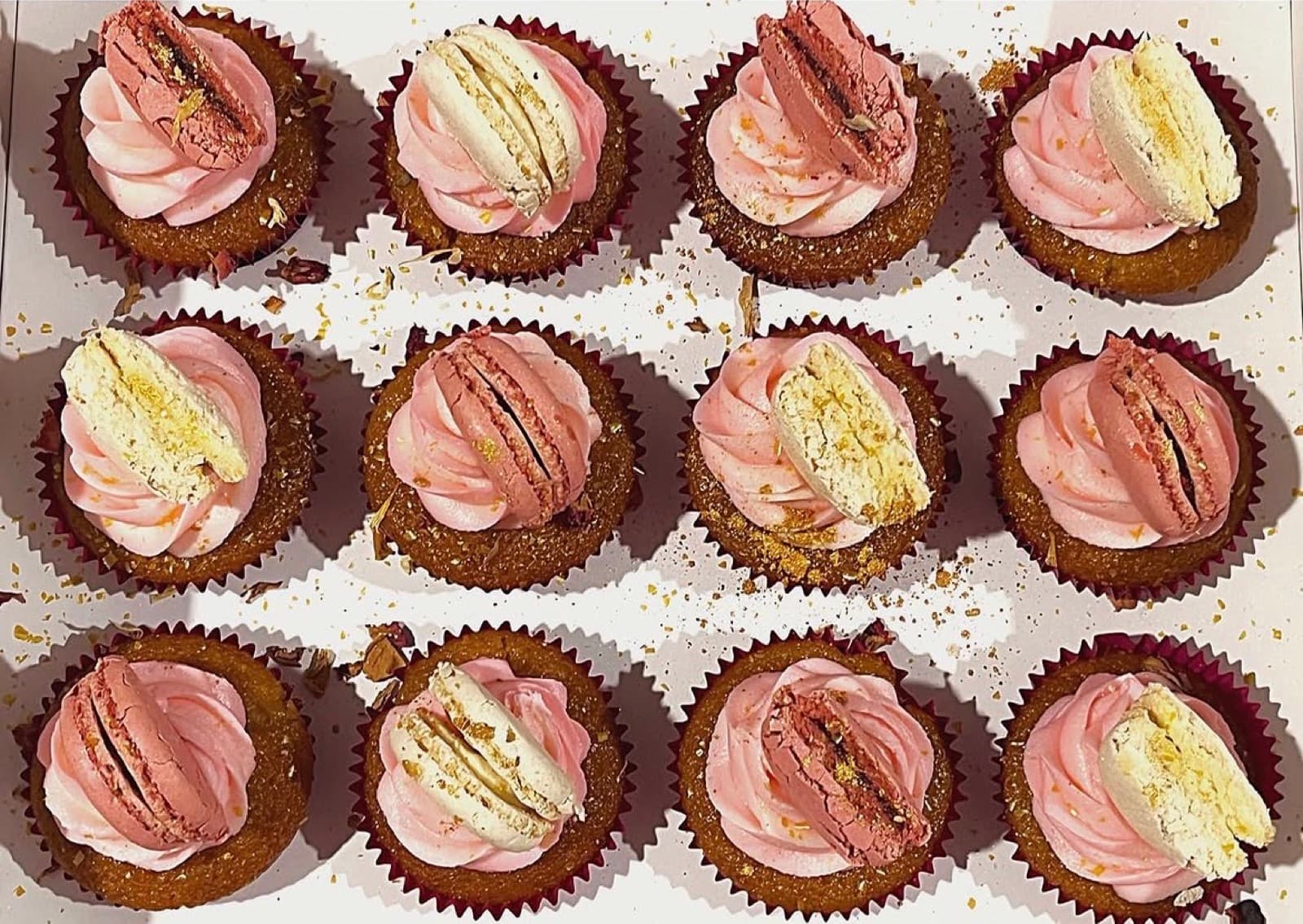 Red velvet cupcakes with pink buttercream and macaron halves
