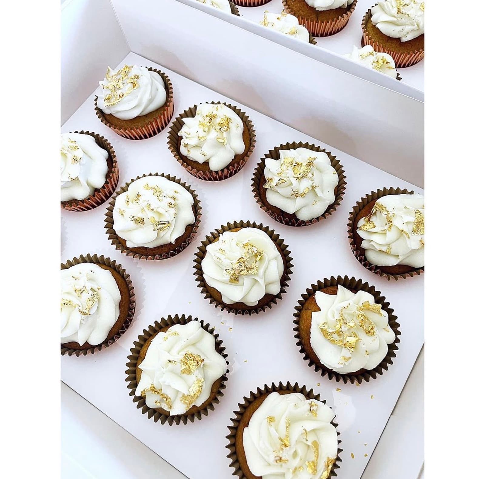 Chocolate cupcakes with white buttercream and gold leaf