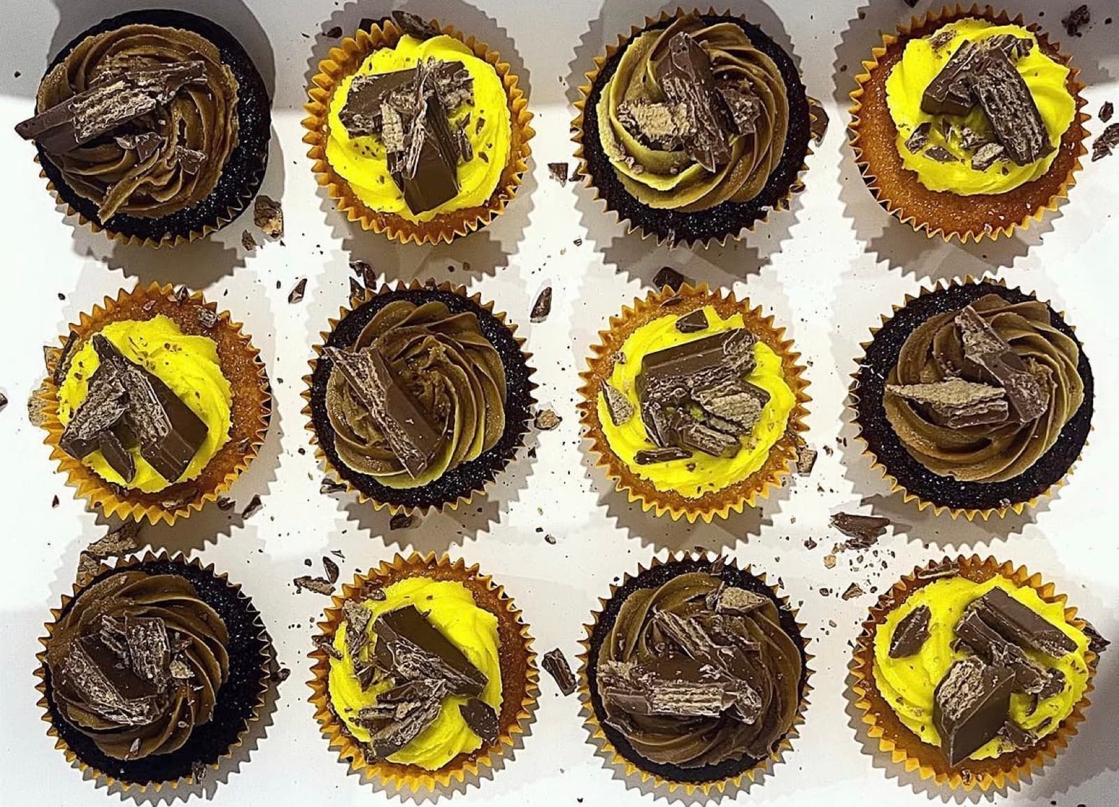 Chocolate cupcakes with yellow buttercream and Flake bars